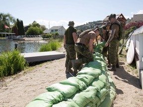Canadian Armed Forces make sandbag walls along shoreline of Lake Okanagan in West Kelowna, B.C., on Monday, May 21, 2018.THE CANADIAN PRESS/Jeff Bassett