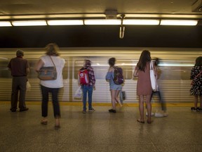 Commuters wait to take the subway at Christie Station in Toronto on Friday, June 22, 2018. For the first time in two years, travelers in Ontario this week could opt to go unmasked on public transit.