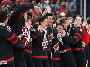 Canada celebrates their 6-2 victory over Sweden following the Hlinka Gretzky Cup gold medal game in Edmonton on Saturday, August 11, 2018.&ampnbsp; Hockey Canada has announced Stephane Julien will lead its men's under-18 team at the upcoming Hlinka Gretzky Cup.