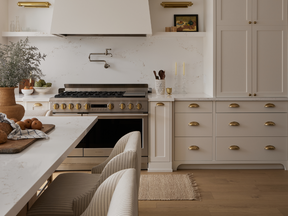 Home tour: Classic coastal in the city - alberta news headlines Shaker doors and brass lighting give the kitchen a timeless feel. “We gave them a 48-inch range with a griddle for pancakes on the weekend,” says interior designer Laura Collins.