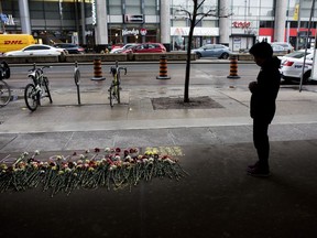 Eine Frau hält an, um einem der Opfer, an die am Dienstag, den 23. April 2019, erinnert wird, an einem provisorischen Denkmal ihren Respekt zu erweisen. Opfer und Familien des tödlichen Van-Angriffs in Toronto werden heute vor Gericht aussagen.THE CANADIAN PRESS/Chris Young