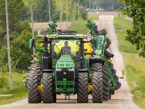 Farm equipment moves down a Southwestern Ontario road on May 26.