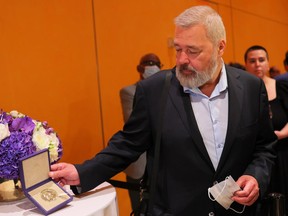 Dmitry Muratov, editor-in-chief of the Russian newspaper Novaya Gazeta, poses for photos with his 2021 Nobel Peace Prize at The Times Center on June 20, 2022 in New York City.