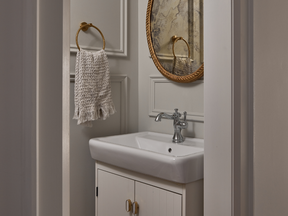 Home tour: Classic coastal in the city - alberta news headlines Wood and marble mix in the bathroom, which features a furniture-like vanity.
