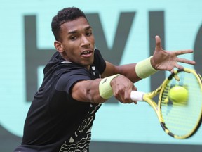 Canada's Felix Auger-Aliassime returns a ball to Poland's Hubert Hurkacz in their ATP Tour men's singles quarterfinals tennis match in Halle, Germany, Thursday, June 16, 2022.