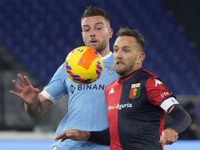 Genoa's Domenico Criscito, right, and Lazio's Sergej Milinkovic-Savic, left, vie for the ball during the Italian Series A soccer match between Lazio and Genoa, at Rome's Olympic stadium on December 17, 2021.