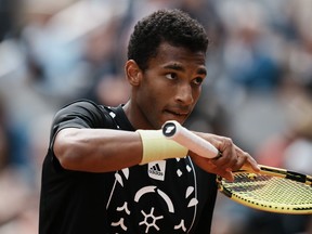 Canada's Felix Auger-Aliassime prepares to serve against Spain's Rafael Nadal during their fourth round match at the French Open tennis tournament in Roland Garros stadium in Paris, France, Sunday, May 29, 2022. Auger-Aliassime is out of the Libema Open grass-court tennis tournament after being upset in the semifinals by&ampnbsp; Tim van Rijthoven of the Netherlands on Saturday.