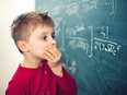 Little boy in math class overwhelmed by the math formula