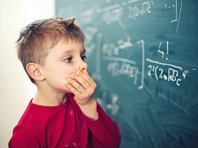 Little boy in math class overwhelmed by the math formula