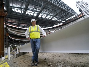 Oak View Group co-founder Tim Leiweke poses with the last piece of metal to be used in a topping off ceremony this week as construction continued on the New York Islanders new UBS Arena, Wednesday, Oct. 7, 2020, in Elmont, N.Y.