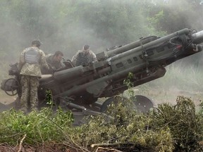 Ukrainian soldiers prepare to fire at Russian positions from a U.S.-supplied M777 howitzer in Ukraine's eastern Donetsk region Saturday, June 18, 2022.THE CANADIAN PRESS/AP Photo/Efrem Lukatsky