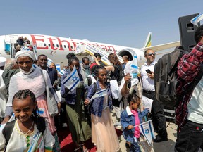 Ethiopian-Jewish immigrants arrive in Israel on a special plane chartered by the Jewish Agency, at the Ben Gurion Airport in Lod on June 1.