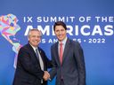 Argentinan President Alberto Fernandez, left, and Prime Minister Justin Trudeau shake hands during a meeting in Los Angeles, on June 9. Trudeau later tested positive for COVID-19.