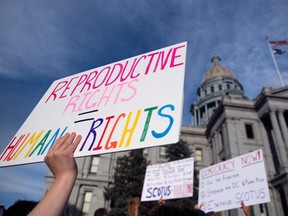 Abortion rights activists protest in front of the Colorado State Capitol in Denver, Colorado on June 27, 2022, four days after the US Supreme Court struck down the constitutional right to abortion. (Photo by Jason Connolly / AFP)