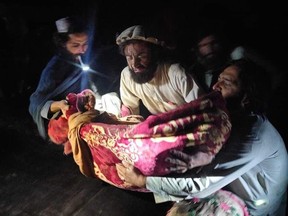 Afghans evacuate wounded Wednesday after an earthquake hit the province of Paktika, eastern Afghanistan.
