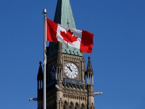 A Canadian flag flies in front of the Peace Tower on Parliament Hill in Ottawa, Ontario, Canada. REUTERS/Chris Wattie/File Photo