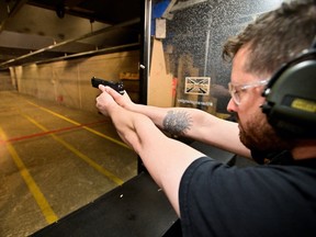 Andrew Trafananko, General Manager of the Range Langley, fires a handgun after Canada's government introduced legislation to implement a "national freeze" on the sale and purchase of handguns.