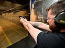 Andrew Trafananko, General Manager of the Range Langley, fires a handgun after Canada's government introduced legislation to implement a 