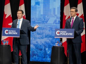 Conservative leadership candidates Patrick Brown, left, and  Pierre Poilievre take part in a debate in Edmonton on May 11.