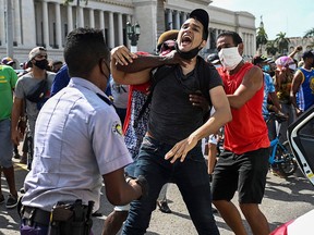 A man is arrested during a demonstration against the government of Cuban President Miguel Diaz-Canel, in Havana on July 11, 2021.