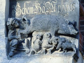 A 13th-century antisemitic sculpture is displayed at St. Marien church in Wittenberg, Germany.