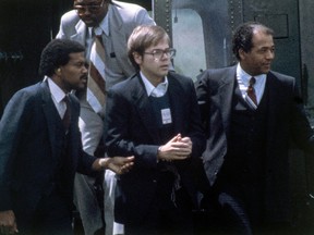 U.S. Marshalls escort John Hinckley Jr. as he returns to a marine base via helicopter in Quantico, Va., Aug. 8, 1981.