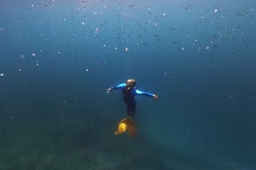 Tabora swims in a monofin as she demonstrates techniques to her mermaiding class in the waters off Mabini.