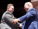 New Ontario Citizenship and Multiculturalism Minister Michael Ford shakes hands with his uncle Premier Doug Ford at a swearing-in ceremony at Queen’s Park in Toronto on June 24, 2022.