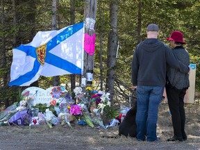 A couple visits a makeshift memorial to victims of the Nova Scotia mass shootings in Portapique, N.S. on April 22, 2020. A culture of openness among police rather than opacity might well have saved lives.