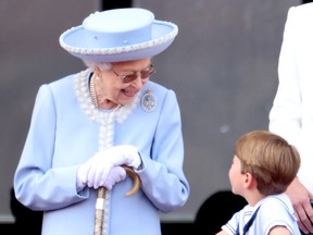 Queen Elizabeth II and Prince Louis of Cambridge on the balcony of Buckingham Palace during Trooping The Colour on June 02, 2022 in London, England. (Photo by Chris Jackson/Getty Images)