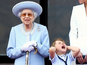 Prince Louis reacts beside his great grandmother, Queen Elizabeth, on the balcony of Buckingham Palace, as fighter jets perform a flyover  during Platinum Jubilee celebrations in London on June 2, 2022.