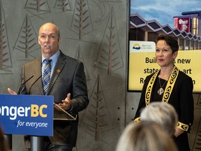 Premier John Horgan, with Tourism Minister Melanie Marks, announces the new Royal B.C. Museum project on May 13, 2022. Plans to close the current museum on Sept. 6, then tear it down and replace it by 2030 have now been halted.