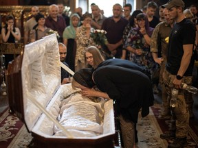 Family and friends attend a funeral service for Ukrainian serviceman Ivan Chekaniuk, who died during a combat mission in Sievierodonetsk, at St. Michael's Golden-Domed Cathedral in central Kyiv, Ukraine June 11, 2022.