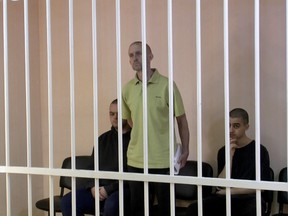 A still image, taken from footage of the Supreme Court of the self-proclaimed Donetsk People's Republic, shows Britons Aiden Aslin, Shaun Pinner and Moroccan Brahim Saadoun captured by Russian forces during a military conflict in Ukraine, in a courtroom cage June 7, 2022. Video released June 7, 2022.