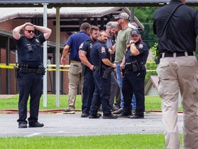 Officials gather outside Walnut Park Elementary School in Gadsden, Ala., following a fatal police shooting on Thursday, June 9, 2022.