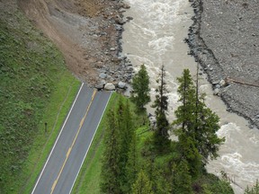 Northeast Entrance Road disappears into Soda Butte Creek following historic flooding in Yellowstone National Park that forced it to shut down last week, June 19, 2022 in Gardiner, Montana.
