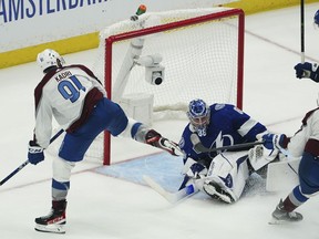 Colorado Avalanche center Nazem Kadri shoots the puck into the top of the goal past Tampa Bay Lightning goaltender Andrei Vasilevskiy (88) for a goal during overtime of Game 4 of the NHL hockey Stanley Cup Finals on Wednesday, June 22, 2022, in Tampa, Fla.