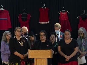 Justice Minister David Lametti, Crown-Indigenous Relations Minister Marc Miller and Indigenous Services Minister Patty Hajdu and other women listen to Hilda Anderson-Pyrz, chairwoman of the National Family and Survivors Circle, speak during an event in Gatineau, Que., on Friday marking the first anniversary of a national plan to end violence against Indigenous Women and Girls.
