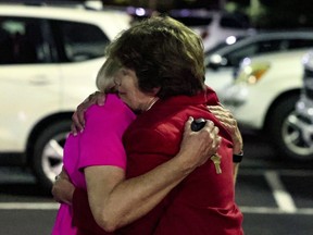 Church members console each other after a shooting at the Saint Stevens Episcopal Church on Thursday, June 16, 2022 in Vestavia, Ala.