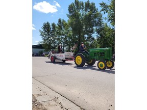 Organizers of a rodeo in Sundre, Alta., are apologizing for a parade float, seen here in a Saturday, June 25, 2022, handout photo, with a turban-wearing man in a fake beard seated on a manure spreader with the words "The Liberal" painted on the side.