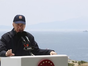 In this handout photo provided by the Turkish Presidency, Turkish President Recep Tayyip Erdogan speaks during the final day of military exercises that were taking place in Seferihisar near Izmir, on Turkey's Aegean coast, Thursday, June 9, 2022. Erdogan on Thursday warned Greece to demilitarize islands in the Aegean, saying he was "not joking" with such comments. Turkey says Greece has been building a military presence on Aegean in violation of treaties that guarantee the unarmed statues of the islands. (Turkish Presidency via AP)