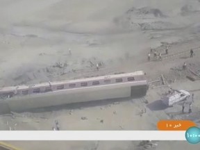 This image taken from video from Iranian state television shows a train car on its side after a derailment outside of Tabas, Iran, Wednesday, June 8, 2022. A passenger train partially derailed in eastern Iran early Wednesday, killing at least 17 people and injuring 50 more, including some critically, authorities said.