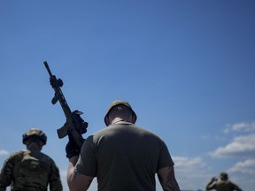 A civilian militia man holds a rifle during training at a shooting range in outskirts Kyiv, Ukraine, Tuesday, June 7, 2022.&ampnbsp;A University of Calgary analysis of over 6 million tweets and retweets - and where they originate from - has found that Canada is being targeted by foreign powers trying to influence public opinion here.