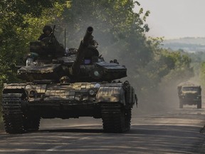 A Ukrainian tank drives in Donetsk region, eastern Ukraine, Thursday, June 9, 2022.