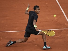 Canada's Felix Auger-Aliassime plays a shot against Spain's Rafael Nadal during their fourth round match at the French Open tennis tournament in Roland Garros stadium in Paris, France, Sunday, May 29, 2022.&ampnbsp;Auger-Aliassime advanced to the semifinals of the Libema Open grass-court tennis tournament with a 7-6 (5), 6-4 win over Karen Khachanov on Friday.