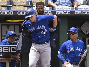Toronto Blue Jays' Zack Collins is helped into the team's home run jacket by teammate Raimel Tapia after hitting a home run against the Kansas City Royals during the third inning of a baseball game in Kansas City, Mo., Wednesday, June 8, 2022.&ampnbsp;Collins was recalled by the Toronto Blue Jays from their triple-A affiliate in Buffalo, N.Y., on Saturday.