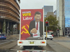 FILE - A truck sponsored by conservative lobby group Advance Australia displaying an image of Chinese President Xi Jinping casting a vote for the Australian opposition Labor Party drives down a local street, Saturday, April 9, 2022, in the Parramatta area of Sydney. The previous Australian government's stance against a more aggressive China drove away many Chinese-Australian voters at recent elections who considered the administration's language had licensed racism, a campaign strategist said on Wednesday, June 15, 2022. (AP Photo, File)