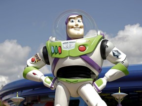 FILE - Character Buzz Lightyear stands near the entrance to the Aliens Swirling Saucers ride at Toy Story Land in Disney's Hollywood Studios at Walt Disney World in Lake Buena Vista, Fla., June 23, 2018. Malaysia's film censors said Friday, June 17, 2022, that it was Disney's decision to ax the animated film "Lightyear" from the country's cinemas after refusing to cut scenes promoting homosexuality.