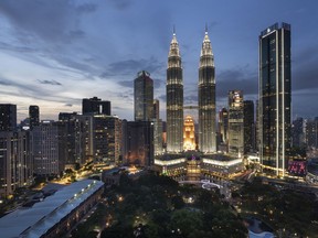 FILE The Petronas Twin Towers, center, stand at sunset in downtown Kuala Lumpur, Malaysia, Wednesday, Aug. 26, 2020. The Malaysian government said in a statement issued Friday, June 10, 2022, that it will abolish the mandatory death penalty and to substitute the punishment with other punishments upon the court's discretion.