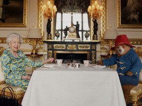 Undated image of Britain's Queen Elizabeth and Paddington Bear having cream tea at Buckingham Palace taken from a film.